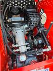 Vorx NL360 engine bay: 13 HP gasoline engine, hydraulic pump, cooling fan and hydraulic hoses