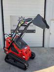 Vorx NL360 stand-on mini skid steer with bucket raised high, rubber tracks and joystick controls