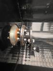 Drive-end shaft flange and bolts where the mixing shaft passes through the side wall of a bucket