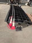 Mixer bucket grid cover with two hydraulic hoses and red flat-face couplers, motor end plate and data plate