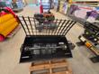 Black mixer bucket with grid lid raised, mixing shaft and paddles inside, resting on a pallet