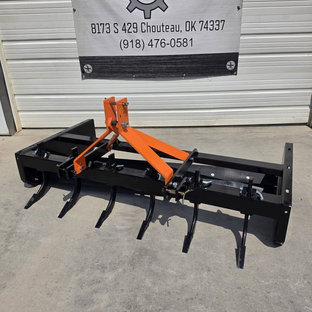 Wolverine 3-point box blade with six ripper shanks lowered, orange hitch tower and black frame
