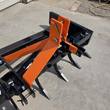 Orange 3-point hitch tower with top-link pin and lower-link pins above the ripper shanks