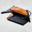 Black and orange brush cutter, angled view, orange motor cover and hydraulic hoses looped on the right