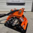 Wolverine E-VPC06 plate compactor, orange pin-on bracket, hydraulic motor and warning decal on the frame