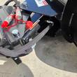 Hydraulic quick couplers with red dust caps and sleeved hoses on the Wolverine M-DB43 dozer blade mount