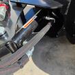 Hydraulic angle cylinder and sleeved hoses routed behind the Wolverine M-DB43 dozer blade