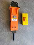 Orange Wolverine S-EB35 hydraulic breaker from above, black mounting bracket at top, chisel at bottom, toolbox beside it