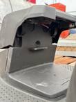 Front of a robotic mower with the cover raised, showing the bumper mount and wiring
