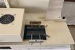 Conveyor belt with adjustable guide rails under the induction sealer's sealing head