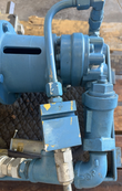 Blue gear pump, hydraulic tubing and check valve beside the motor, viewed from above