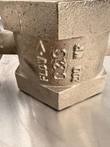 Cast markings on a bronze-colored valve body: flow arrow and C&C logo