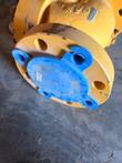 Flanged end of a yellow 4 inch Class 900 check valve with a blue protective cap over the bore