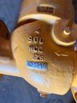 Cast markings on a yellow check valve body: 4, 900, WCC, flow arrow and CAM mark