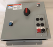 Closed Eaton Cutler-Hammer 460-volt enclosure with red and black disconnect handle, reset button and stop/start station