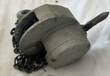 Gray Yale manual chain hoist with the load chain piled beside it and the hand lever on the right