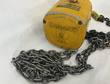 Yellow Budgit 1 ton chain hoist end cover and data plate with the load chain coiled in front