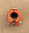 Red ductile iron grooved pipe coupling, end view of the bolted two-piece housing and gasket teeth