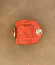 Red ductile iron coupling housing, top view with bolt and cast 1 1/2 size marking