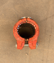 Red grooved pipe coupling, end view showing the rubber gasket and gripping teeth