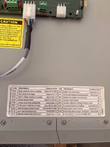 Error and status code label inside the charger door listing codes E01 to E14 and A01 to A05
