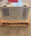 Gray battery charger cabinet on a pallet, side with two perforated vent panels and a cover plate