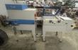 Blue and gray APS shrink wrap system: L-bar sealer with lid raised beside a heat tunnel, both on casters
