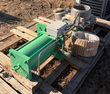 Green hydraulic cylinder with gray junction box and brass solenoid valve; stainless bellows and flange behind