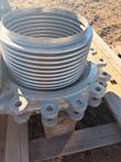 Stainless steel bellows with ribbed folds above a cast flange with threaded bolt lugs