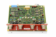 Top view of a GE circuit board with ICs, red LEDs, blue connector and four round connectors on white