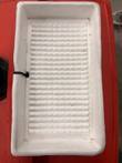 White ribbed plastic drip tray on top of the red cart