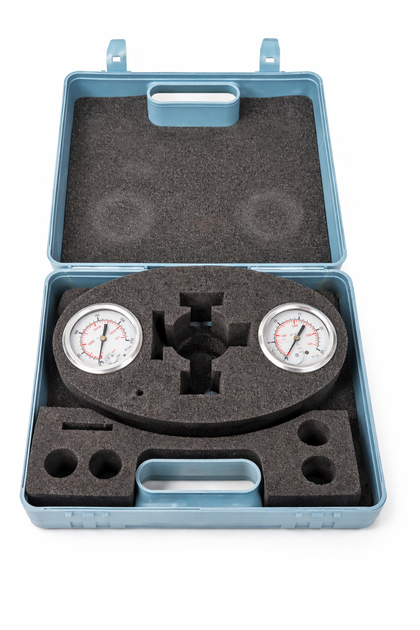 Open blue carrying case with two pressure gauges and cut-out black foam, on white