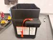 Kaivac OmniFlex battery box side with warning label, serial label and orange strap
