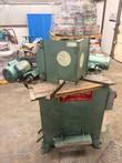 Green double miter saw, front: both heads, angled tables, red Pistorius plate and foot pedal