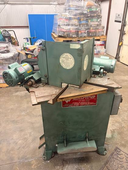 Green double miter saw, front: both heads, angled tables, red Pistorius plate and foot pedal
