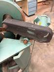 Black mesh belt guard over the drive belt on a green saw head, Baldor motor behind