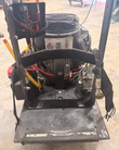 Rear of a propane floor buffer: engine, regulator and battery on the deck, handle frame cut off
