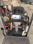 Open handle frame showing the engine, battery strap, wiring and propane fitting on a floor burnisher
