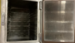 Inside of the Steam 'N' Hold steamer with the door open, showing side rack rails