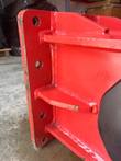 Red hydraulic breaker mounting plate with bolt holes and gusset ribs