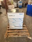 Front of a Follett undercounter refrigerator with control panel, on a wood pallet in a warehouse