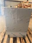Stainless steel undercounter refrigerator from the side, on a wooden pallet