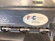 Financial Equipment Company sales and service sticker on dark casing above a roller mechanism