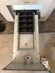 Top-down view into the Glory cassette bay showing eight coin pockets