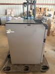 Glory coin recycler from the side, standing on a plastic pallet