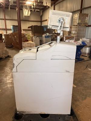 Cream cash recycler cabinet from the side with a flat monitor on an adjustable arm
