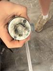 Hand holding a worn twist-lock power plug end