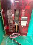Inside the Onan transfer switch: red switch mechanism cover, terminal blocks and warning labels