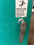 Chrome keyed door handle and hazardous voltage warning label on the transfer switch enclosure