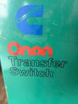 Cummins and Onan Transfer Switch logo decal on the teal enclosure door